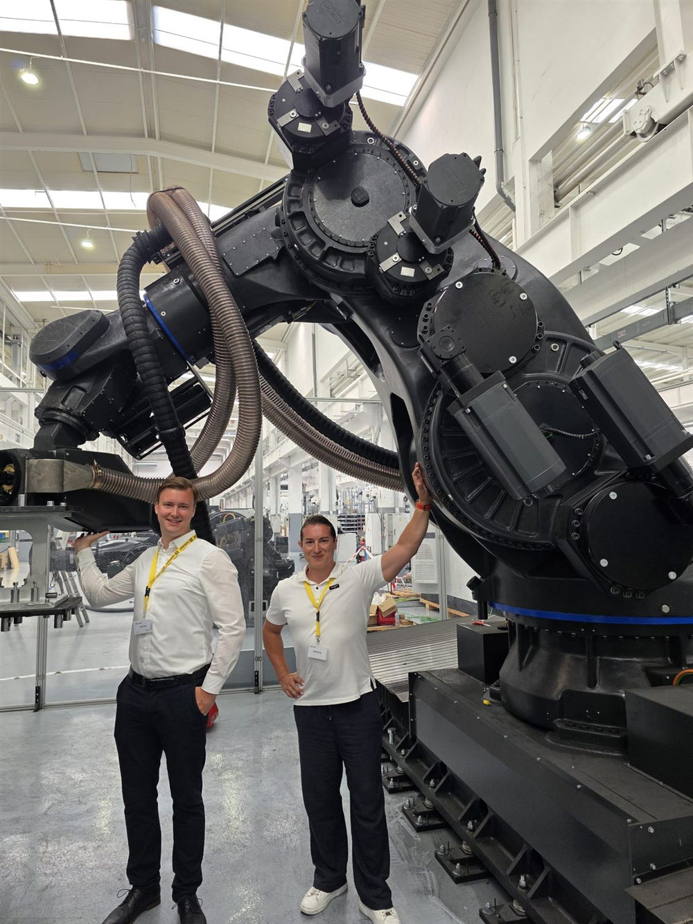 Dr. Arkadi Zikin and Tobias Eisele, founders of AZETRA, standing beside a large industrial robotic deposition cell