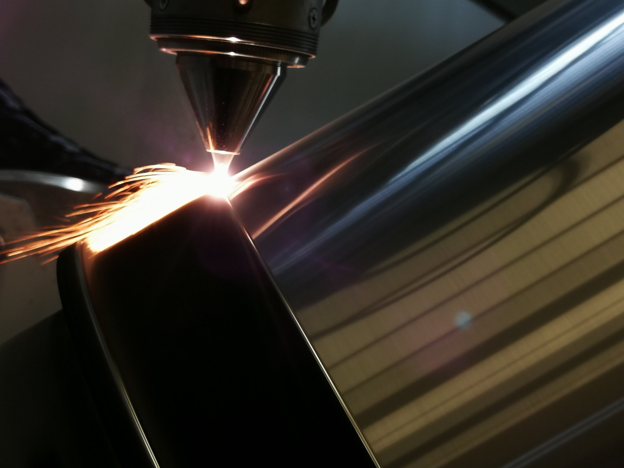 Laser directed energy deposition in progress, molten metal bead being built layer by layer